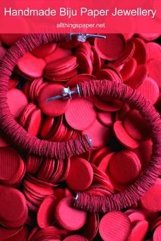 red heart shaped buttons with the words handmade bij paper jewelry