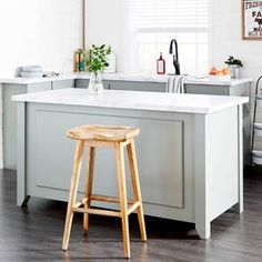 a kitchen with an island and stools in it