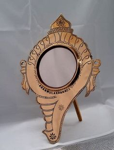 an elephant shaped mirror is sitting on a stand