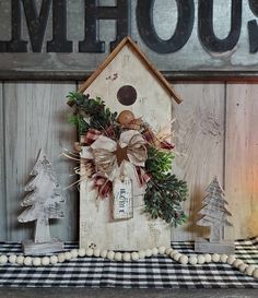 a wooden birdhouse decorated with christmas decorations