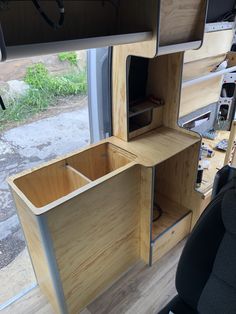 the inside of a camper with its door open and shelves in front of it