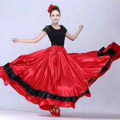 a woman in a red and black dress is dancing