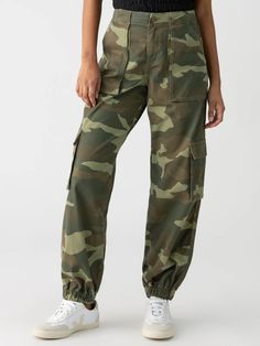 Upgrade your wardrobe with our Cyber Cargo Pants! These relaxed fit pants feature a washed camo print and jogger bottom, perfect for pairing with a slouchy sweater and sneakers. Stay comfortable and stylish with this unique addition to your closet. Washed camo print Button and zip closure Relaxed fit Elastic at the ankle The material is 98% Cotton 2% Spandex. The pants run true to size. The model is 5'9" and is wearing a size small. Care instructions: Machine wash cold, Tumble dry low 2024 Photoshoot, Relaxed Fit Pants, Everyday Pants, Camo Joggers, Slouchy Sweater, Sweater Tank Top, Fit Pants, Dress Trousers, Fall 2024