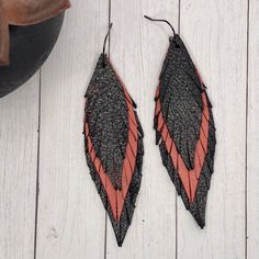 Genuine leather feather earrings feature a beautiful black and coral layered leather These are handmade my me and each pair will be slightly different Approximately 3.5” long surgical steel Hypoallergenic, nickel and lead free Handmade by me Handmade Black Faux Leather Jewelry, Handmade Black Leather Earrings, Black Leather Earrings As A Gift, Adjustable Black Faux Leather Earrings, Closet Revamp, Leather Feather Earrings, Biker Babe, Leather Projects, Feather Earrings