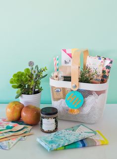 a white bag filled with lots of items on top of a table next to some plants