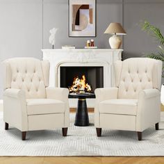 a living room with two chairs and a fire place in the middle of the room