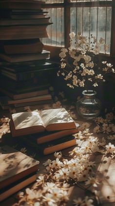 a vase filled with white flowers sitting next to an open book on top of a table