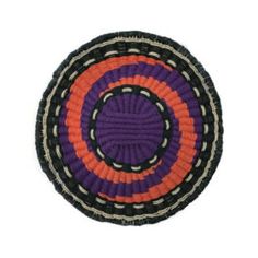 an orange, purple and black basket on a white background