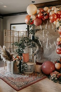 balloons and greenery decorate the entrance to an event