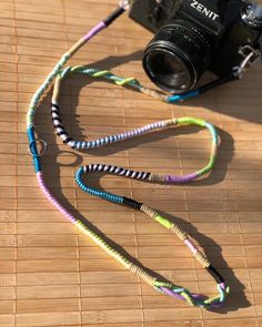 a camera with a colorful lanyard attached to it