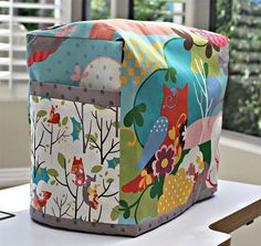 a colorful storage bag sitting on top of a white table in front of a window