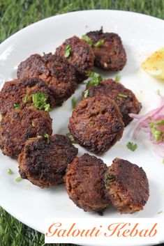 some food is sitting on a white plate with green garnish and red onions