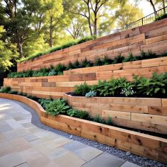 an outdoor garden with wooden steps and plants growing on the sides, along with stone pavers