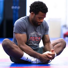 a man sitting on the ground holding a ball