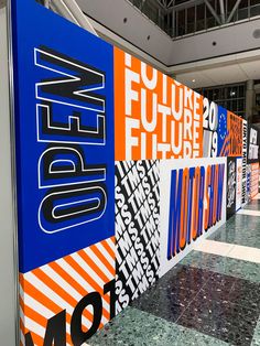 an airport lobby with colorful signs on the wall