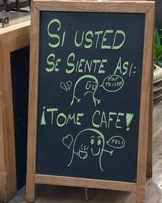 a blackboard sign with green writing on it that says, sisted se sente as i come cafe