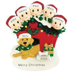 a christmas ornament with five people and a dog sitting in front of it