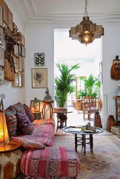 a living room filled with furniture and lots of pictures hanging on the wall above it