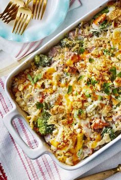 a casserole dish with broccoli, cheese and other vegetables in it