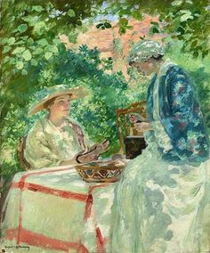 two women sitting at a table in front of trees, one with a basket on her lap