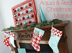 christmas stockings hanging from a mantel in front of a fireplace with ornaments on it