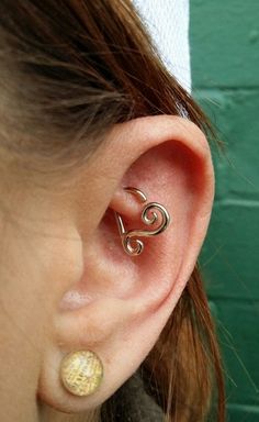 a close up of a person's ear with an ear pin in the middle