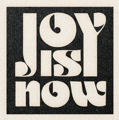 the word joy is now written in white on a black and white square paper background