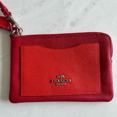 ** Color: Red (Front Pocket Has A Lighter Tone) ** Two Credit Card Slots On The Inside ** Zip-Top Closure ** Silver Details ** Perfect Size For Cards And Cash ** Never Used, Like New Red Rectangular Wallet With Zipper Pouch, Red Clutch Wallet With Zipper Pouch, Red Zipper Pouch Wallet Clutch, Red Rectangular Coach Wallet, Red Pouch With Card Slots For Daily Use, Coach Red Rectangular Wallet, Red Wristlet With Removable Pouch For Daily Use, Red Wristlet With Removable Pouch For Travel, Red Wristlet With Removable Pouch