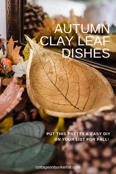 autumn clay leaf dishes on display in front of a mirror with leaves and acorns