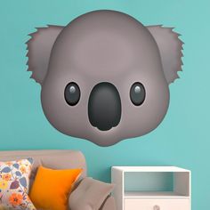 a wall decal with a koala bear's head on it, in front of a blue background