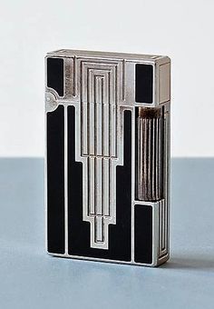 a black and silver lighter sitting on top of a table