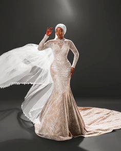 a woman in a white dress and veil posing for a photo on a dark background