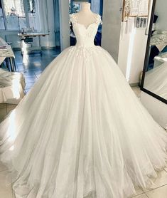 a white wedding dress on display in a store