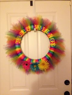 a colorful wreath is hanging on the front door