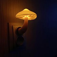 a mushroom shaped light is on the wall