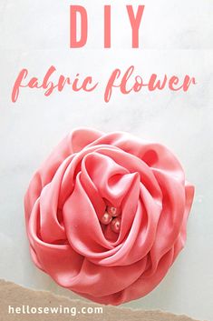 a pink flower with the words diy fabric flower on it in front of a white background