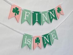 the bunting is decorated with green and pink flags