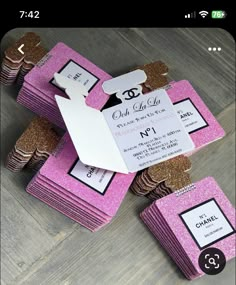 pink and gold glitter wedding favors with white tags on the top are stacked up against each other