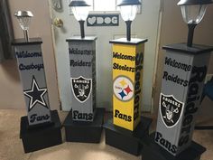 three football trophies are sitting in front of a door with the words welcome to oakland and rams on them