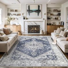 a living room filled with furniture and a large rug on top of a hard wood floor