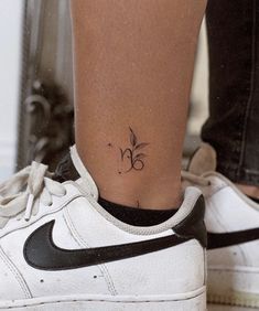 a woman's foot with a small tattoo on her left ankle and the number 35