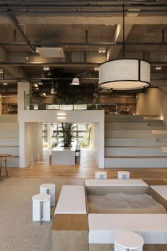 the interior of a modern building with stairs and tables