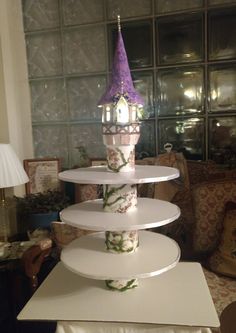 three tiered cake stand with cupcakes on top