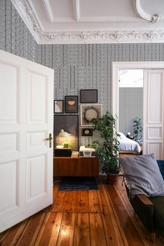 a living room filled with furniture and a wooden floor