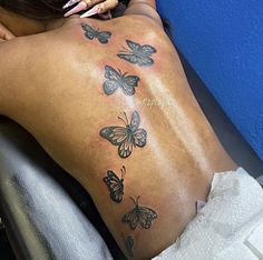 a woman with butterflies on her back