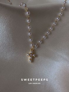 Product Details + Care - 18K Gold Dipped Over Brass - Brass: Copper + Zinc Alloy - 1 Necklace - Wipe Clean - Imported Dimensions - Chain is approximately 16" Have a question? Please message info@shopsweetpeeps.com and our support team will get back to you in 48 hours. Pearl Drop Cross Necklace Gift, Dainty White Cross Necklace, Gold Cross Jewelry With Pearl Charm, Pearl White Cross Necklace Gift, White Pearl Cross Necklace Gift, White Pearl Cross Necklace As Gift, Gold Cross Necklace With Pearl Drop, Gold Pearl Chain Cross Necklace, Pearl Cross Necklace