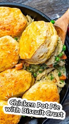 chicken pot pie with biscuit crust in a cast iron skillet on a wooden table