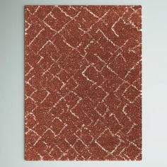 an orange and white rug on a wall