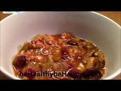 a white bowl filled with food on top of a table