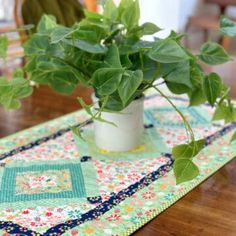 a potted plant sitting on top of a wooden table